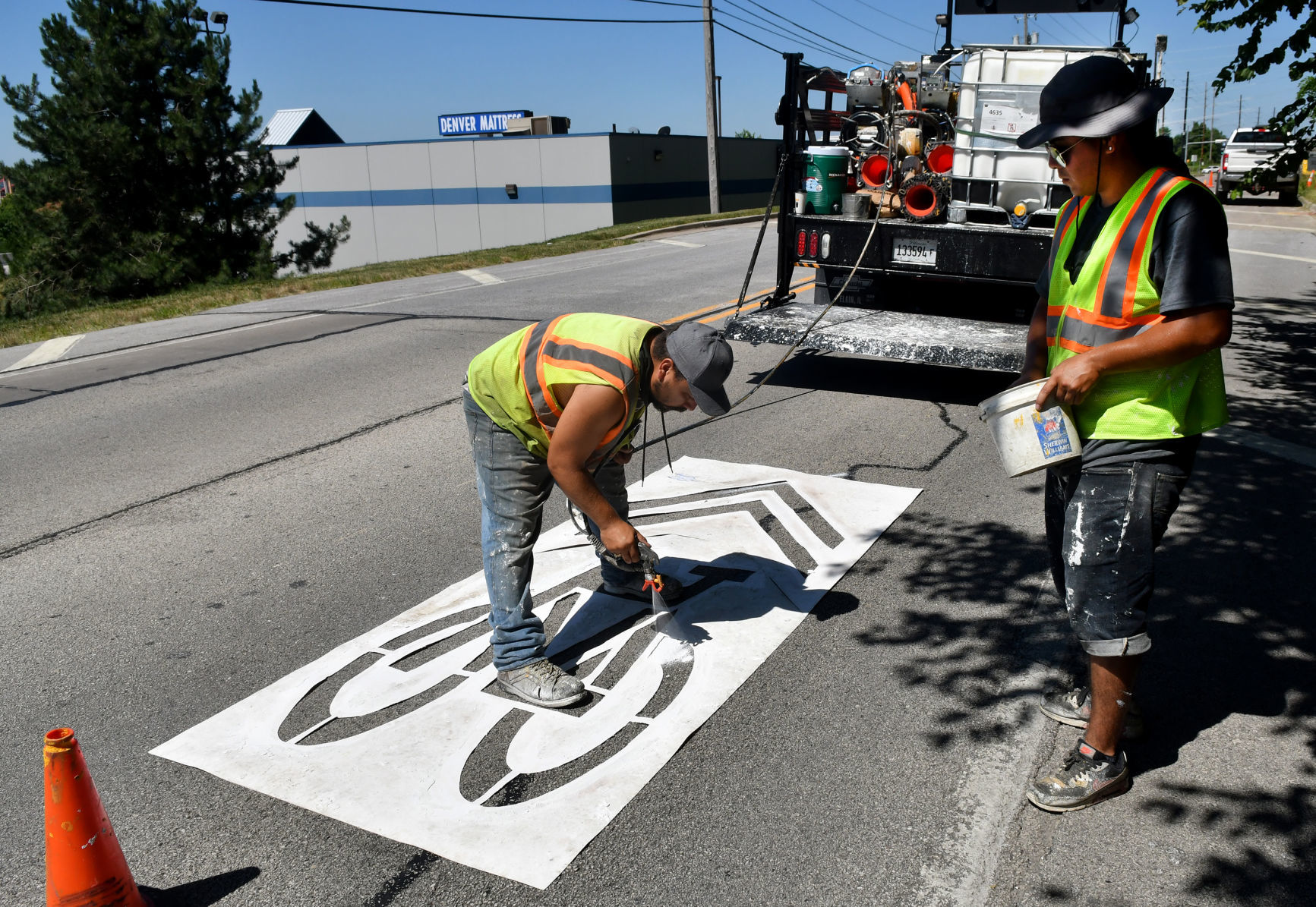 Painting of sharrows for bike lanes in Moline.